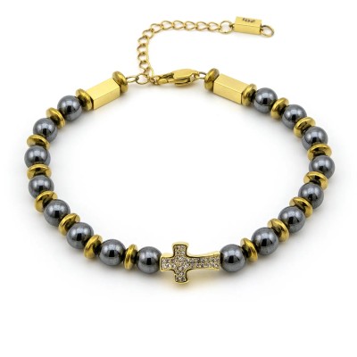 Bracciale in acciaio dorato con ematite nera e charm croce
