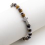 Bracciale in acciaio con pietre occhio di tigre e charm croce